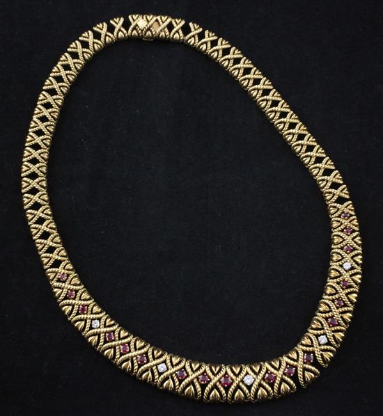 An 18ct gold, ruby and diamond articulated necklace, approx. 16in.